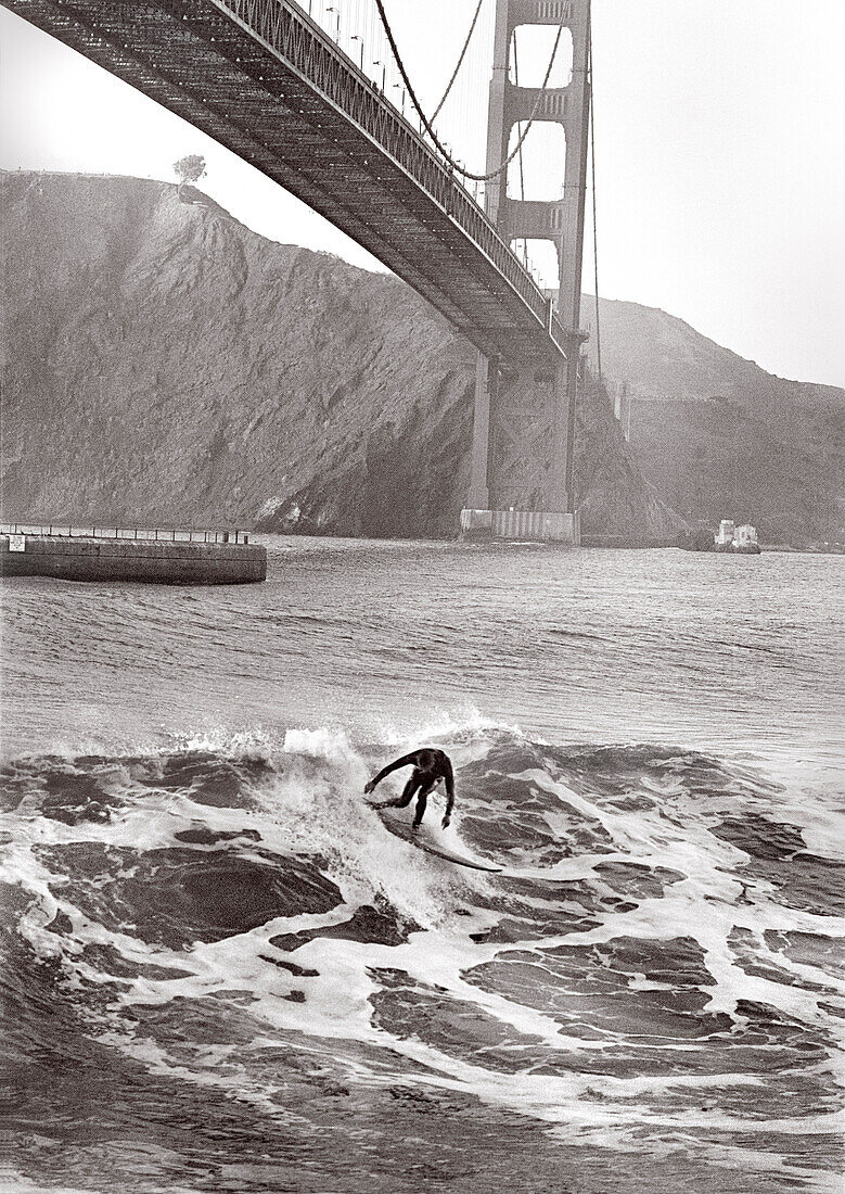 USA, California, San Francisco, person surfing under the Golden Gate Bridge, Fort Point (B&W)