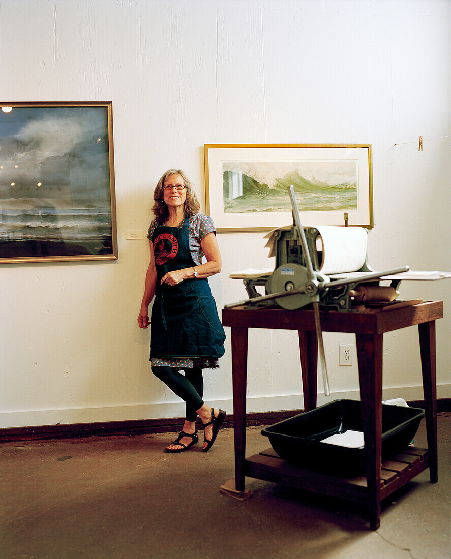 USA, California, Point Reyes Station, portrait of artist and painter Nancy Stein at her show at Toby's Art Gallery, Toby's Feed Barn