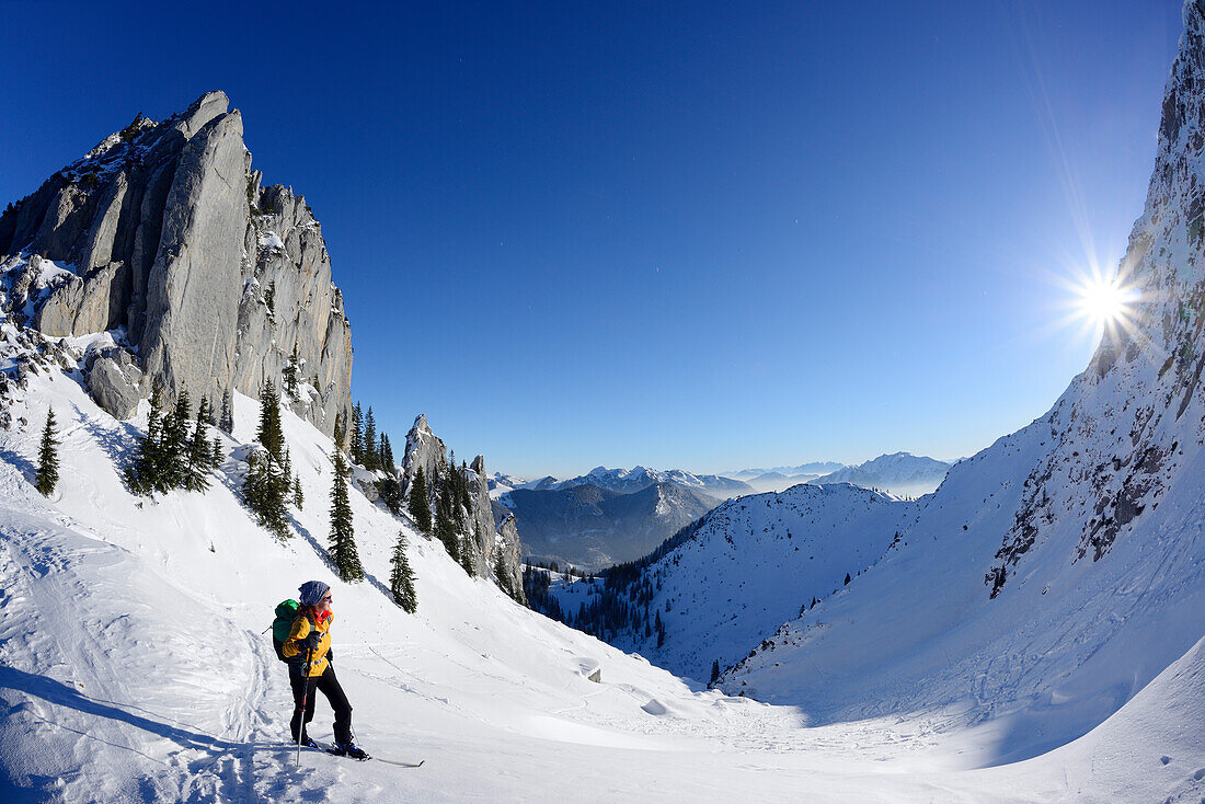 Female backcountry skier ascending to Risserkogel, Blankenstein in background, Bavarian Alps, Upper Bavaria, Bavaria, Germany