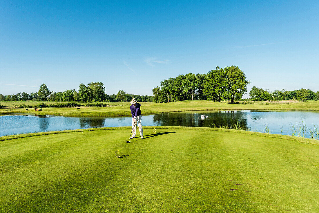 Golfer teeing off,Schleswig-Holstein,Germany