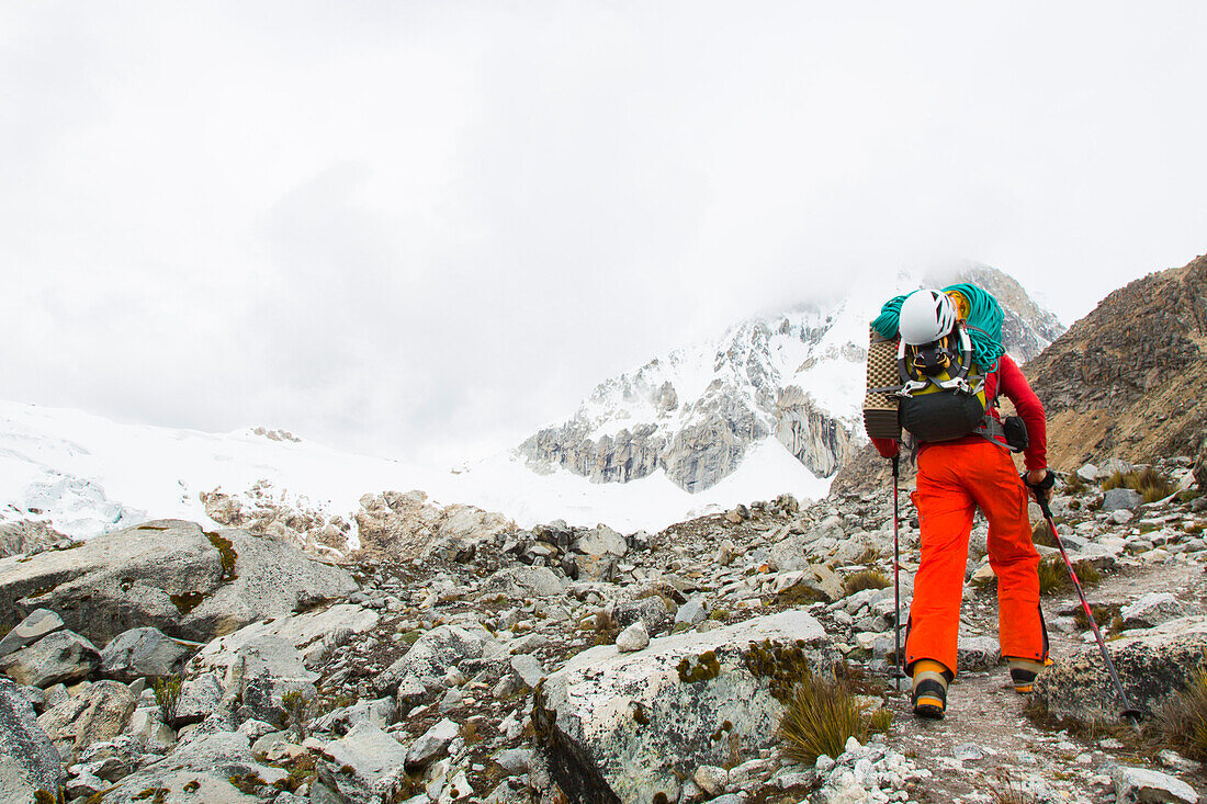 Man ascending to high camp of Ranrapalca, Ishinca Valley, Pashpa, Huaraz, Ancash, Cordillera Blanca, Peru
