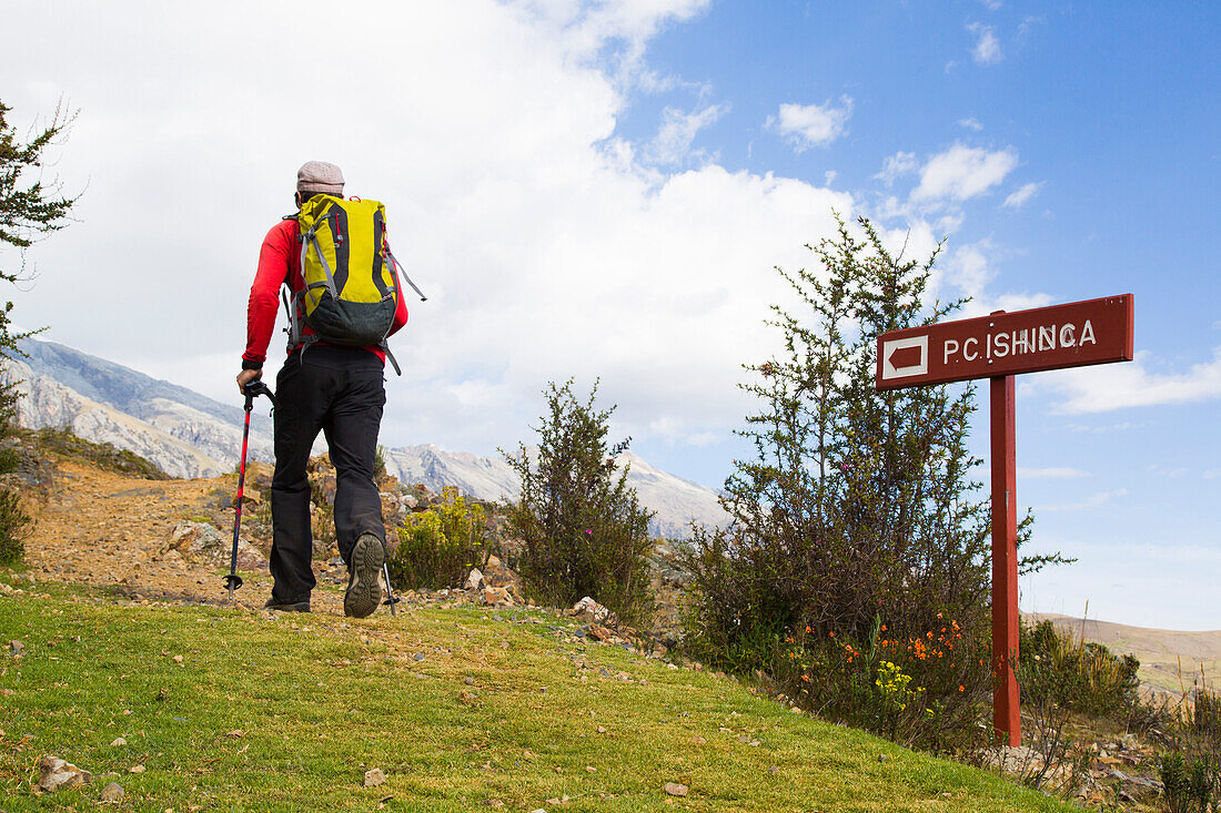 Hiker following signpost to Ishinca Valley, Pashpa, Huaraz, Ancash, Cordillera Blanca, Peru