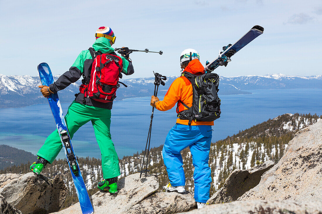Two skiers looking over Lake Tahoe, Heavenly ski resort, California, USA