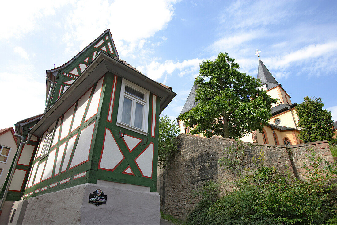 The smallest house and the church of St. Martin, Old town, Bad Orb, Spessart, Hesse, Germany