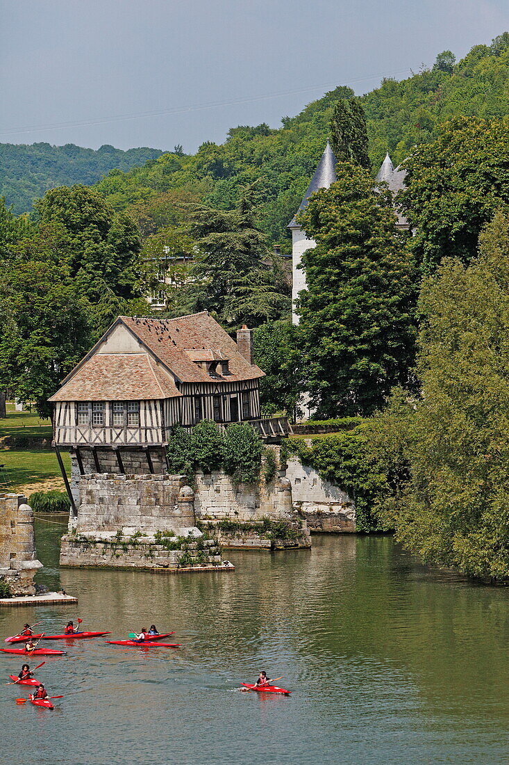 Kayakers on the Seine, ancient mill and the rooftops of Chateau des Tourelles, Vernon, Normandy, France