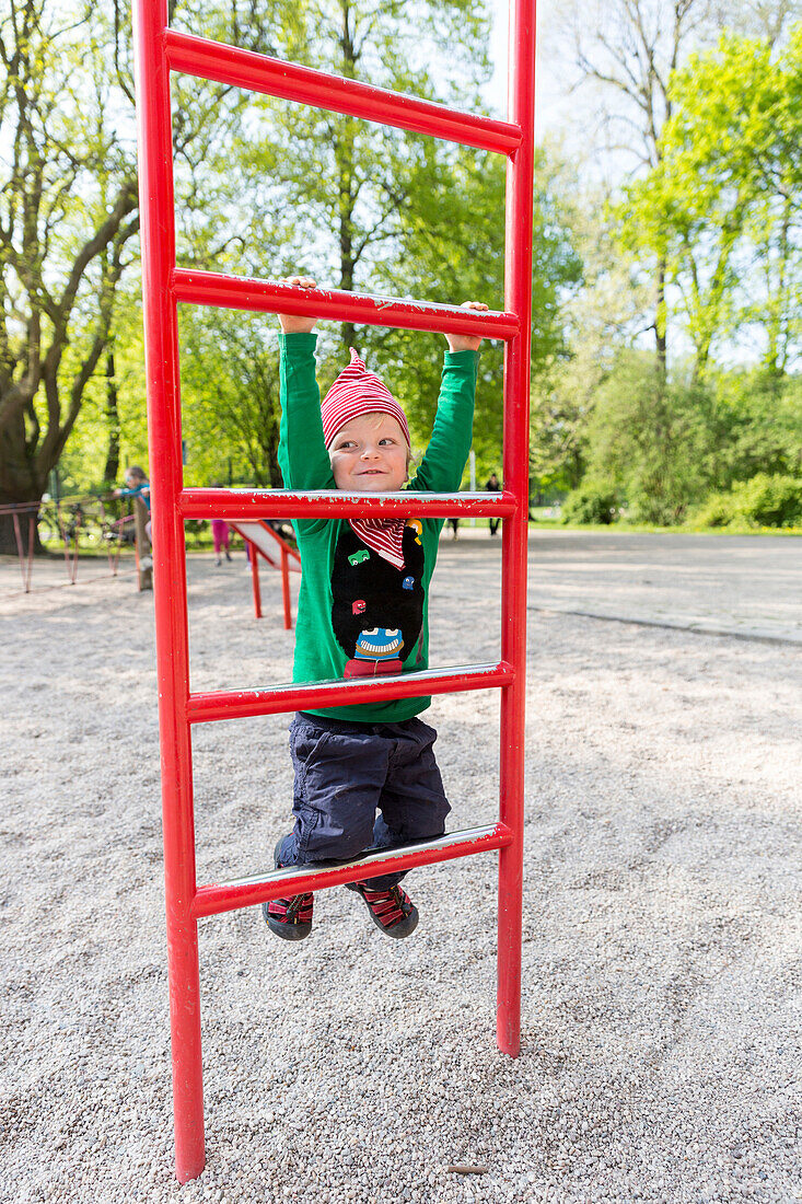 Boy (2 years) at a climbing frame, Clara Zetkin park, Leipzig, Saxony, Germany