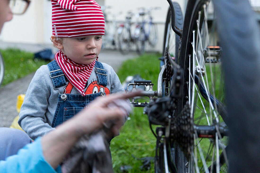 Father and son repairing a bicycle, Leipzig, Saxony, Germany