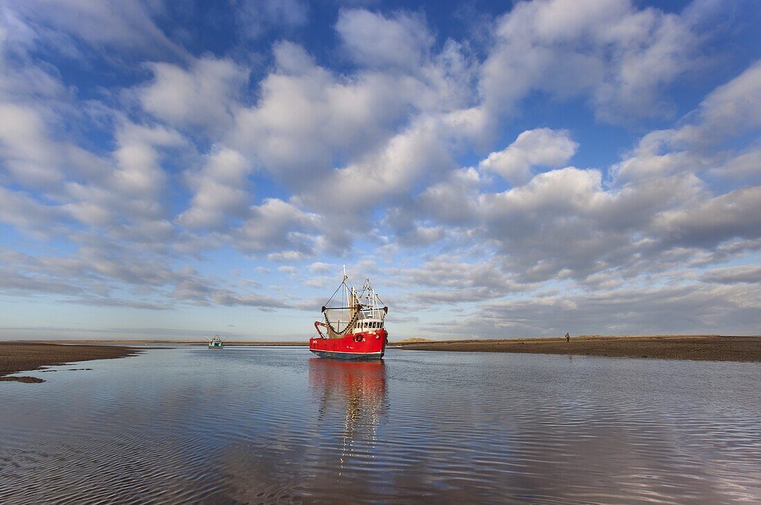 Fishing Boat Brancaster harbour mouth North Norfolk UK Winter