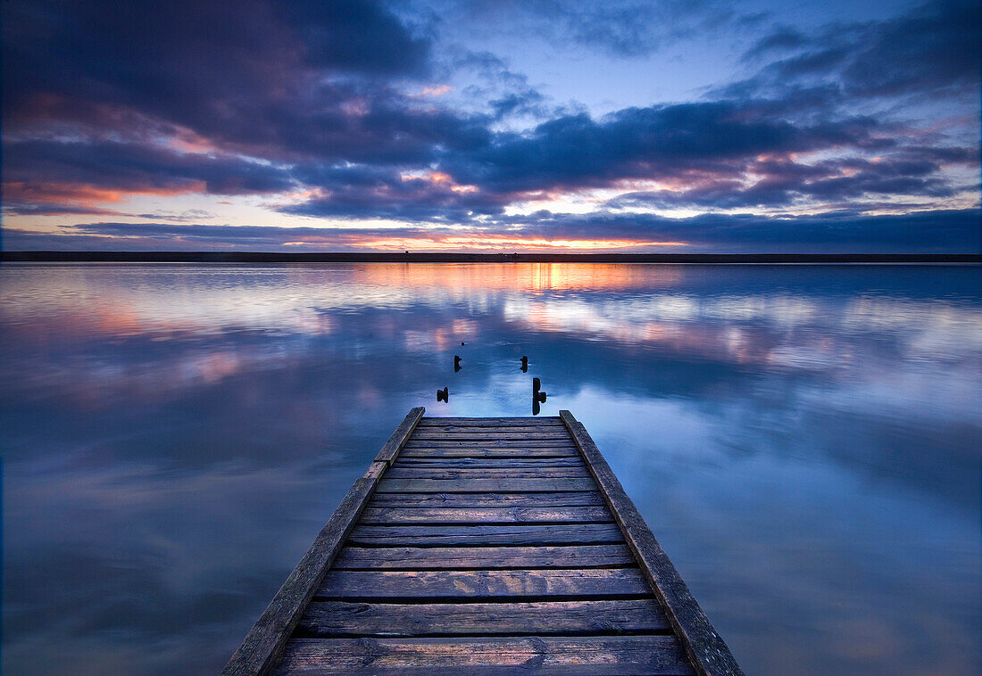 Wooden pier in still lake