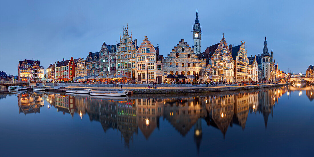 Panorama of the historic guild houses of Graselei with its reflection in the river Lys in the old city of Ghent with the tower of the post office in the background, Gent, Flanders, Belgium