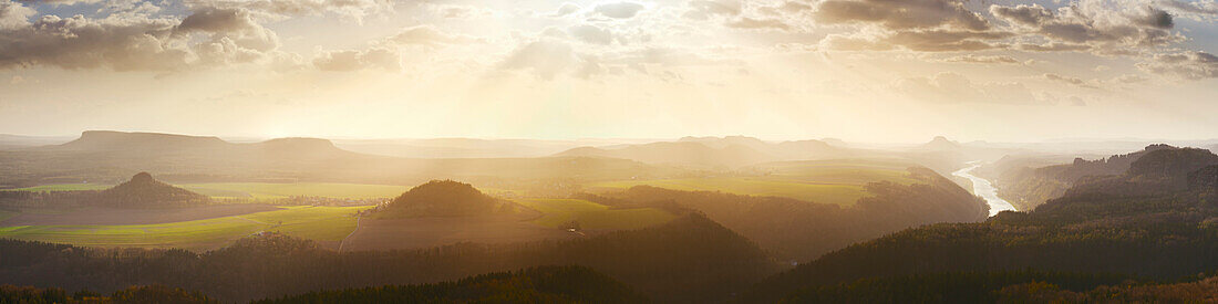 Wide view from the Klipphorn cliff with mellow sunset over the Saxon Switzerland National Park and the Elbe valley in Spring, Saxony, Germany