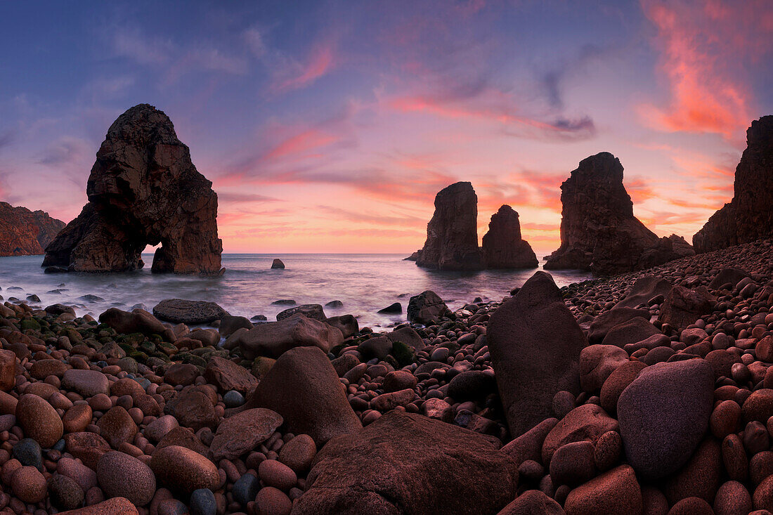 A reddish blaze of colors right after sunset above the rock formations at the Boca do Inferno at the western tip of Europe, Sintra-Cascais National Park, Regiao de Lisboa, Portugal