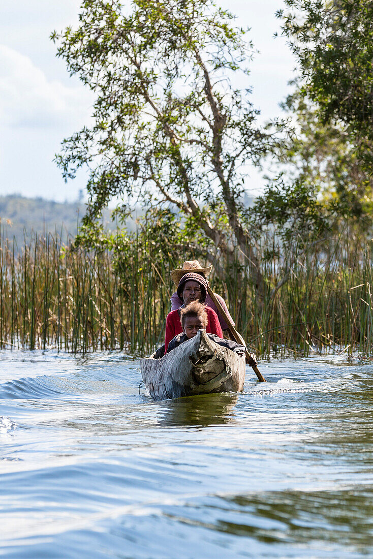 Family in dug out canoe, Canal de Pangalanes, East Madagascar, Africa