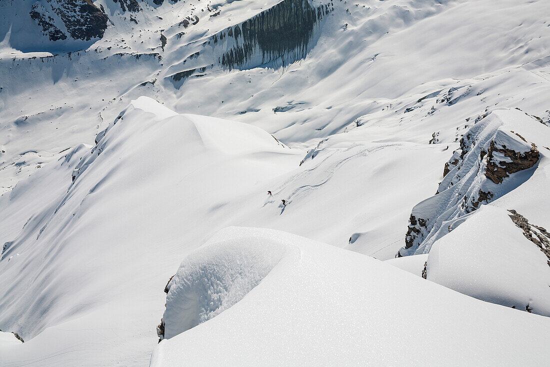Two skiers downhill skiing, Wangerhorn, Turtmann valley, Canton of Valais, Switzerland