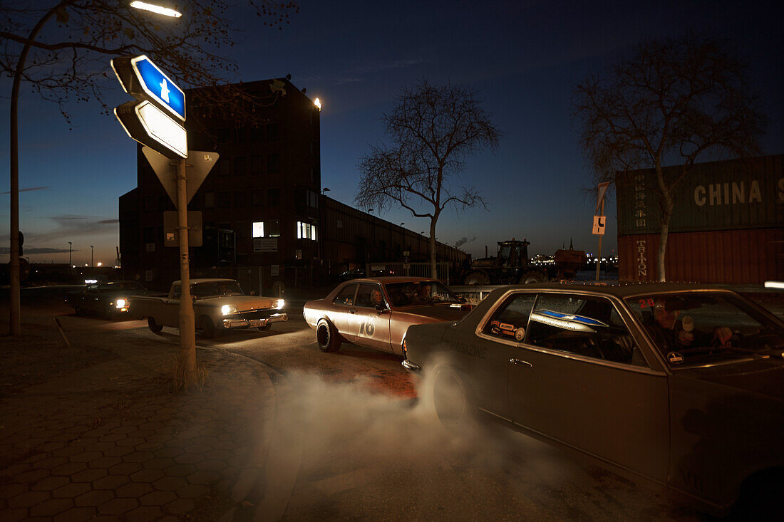 Modern classic cars in harbor area at night, Motoraver group, Hamburg, Germany