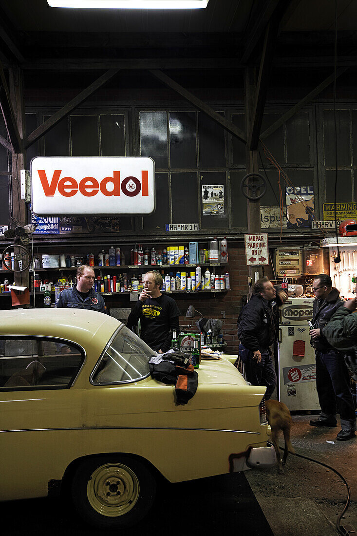 Men of Motoraver group inside a garage, Hamburg, Germany