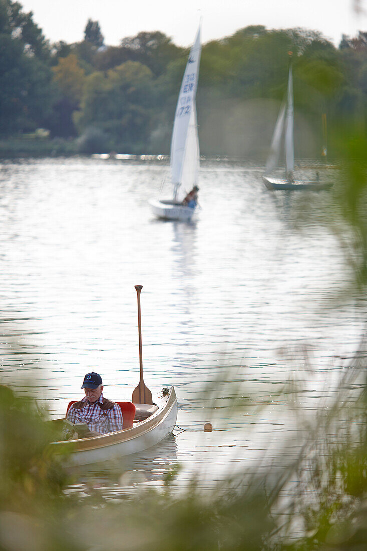 Canoe and sailing boats on the Inner Alster lake, Binnenalster, East bank, Hamburg, Germany