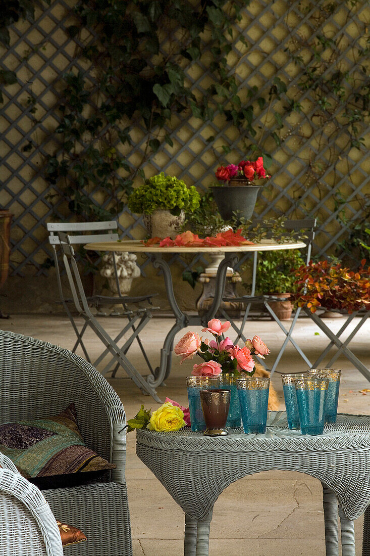 Two tables in a winter garden with flowers and glasses