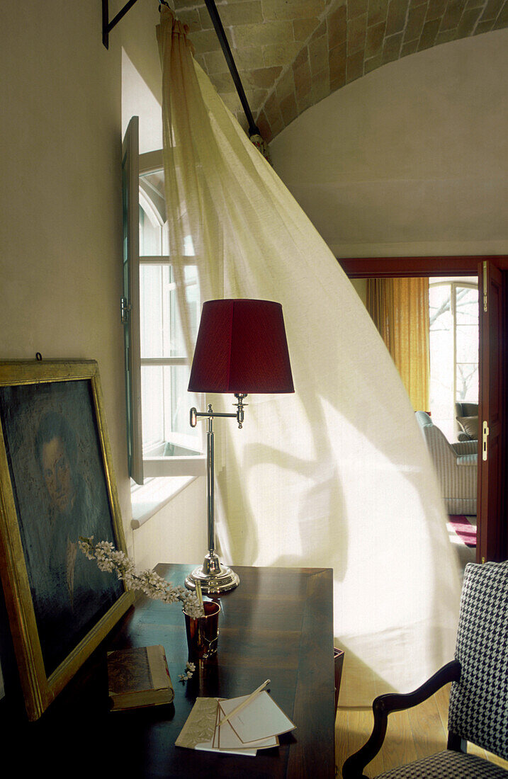 Italy, Tuscany, Inside of a tuscan house, curtains in the wind and red lampshade