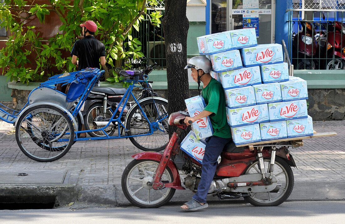 iMan in motorbike delivery bottle of water in Ho Chi Minh City, Vietnam, South East Asia, Asia