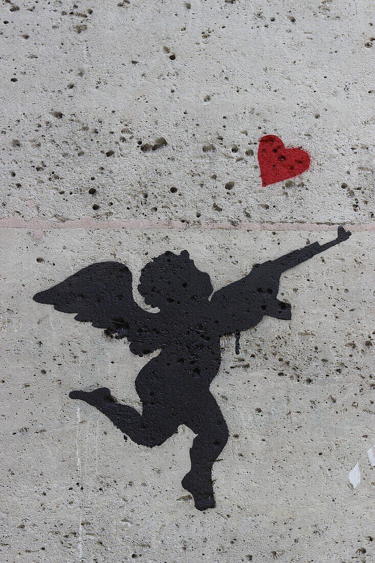 France, Paris, Street Art, Cupid drawn on a wall with a gun and a red heart