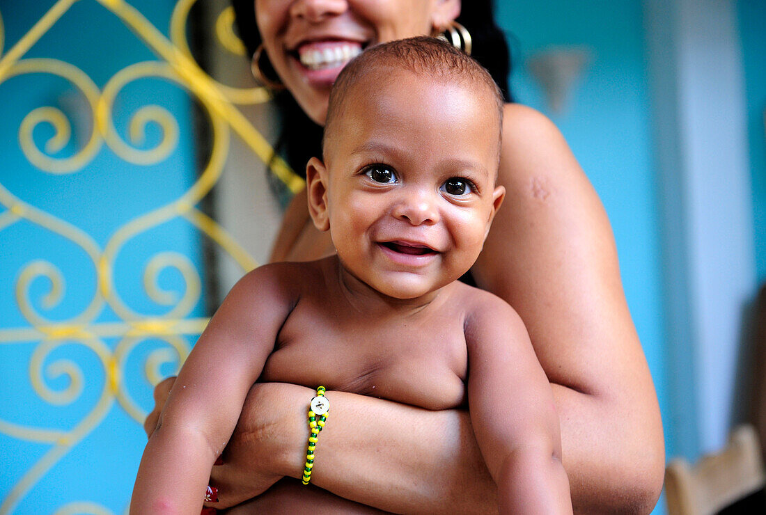 Mother holding baby in her arms in Trinidad, Sancti Spiritus Province, Cuba