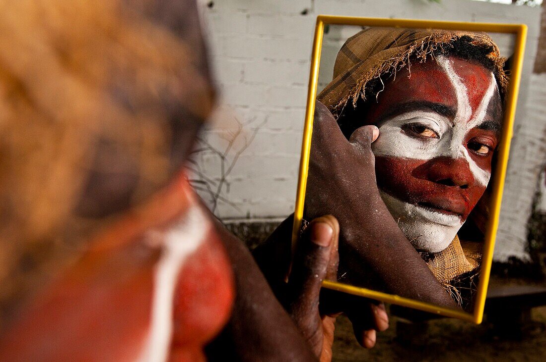 'Africa, Gabon, Estuaire region, Libreville capital, La Sablière, Moroba prepares for a ceremony putting white clay named ''kaolin'' on his face'