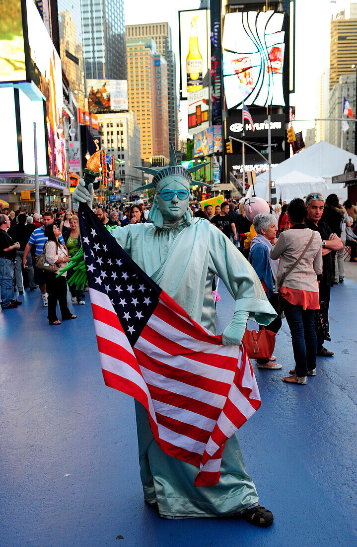 Statue of Liberty costume with american flag in Times Square,  New York City, New York State, United State, USA