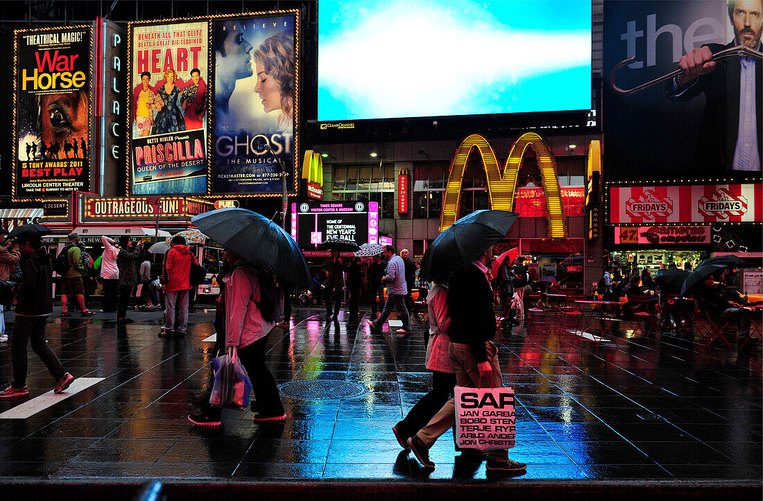 People walking up Broadway in Times Square at night  in New York City, New York State, United State, USA