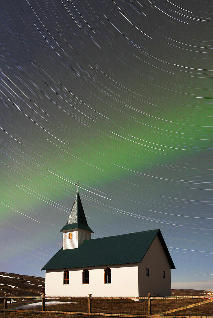 Iceland. Northern region. Efrinupur. Church under the aurora borealis (Surperimposition of photographies of the starry sky taken by night during 50 minutes).