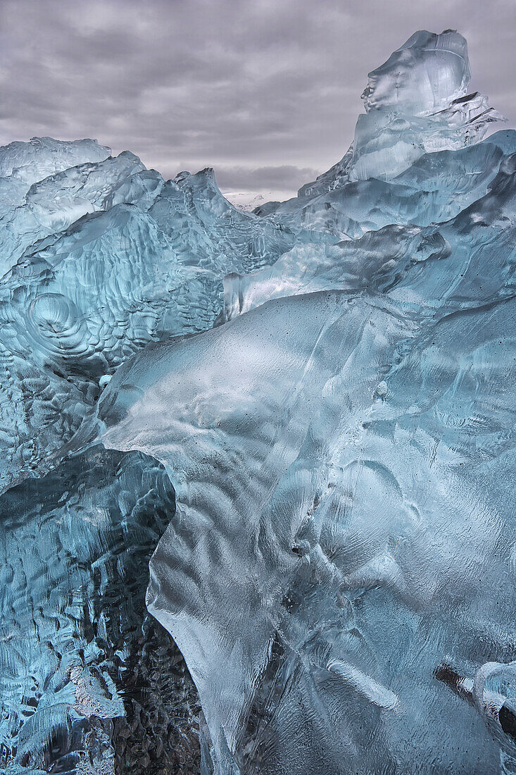 A close-up view of glacial ice strewn across a coastal beach, iceland