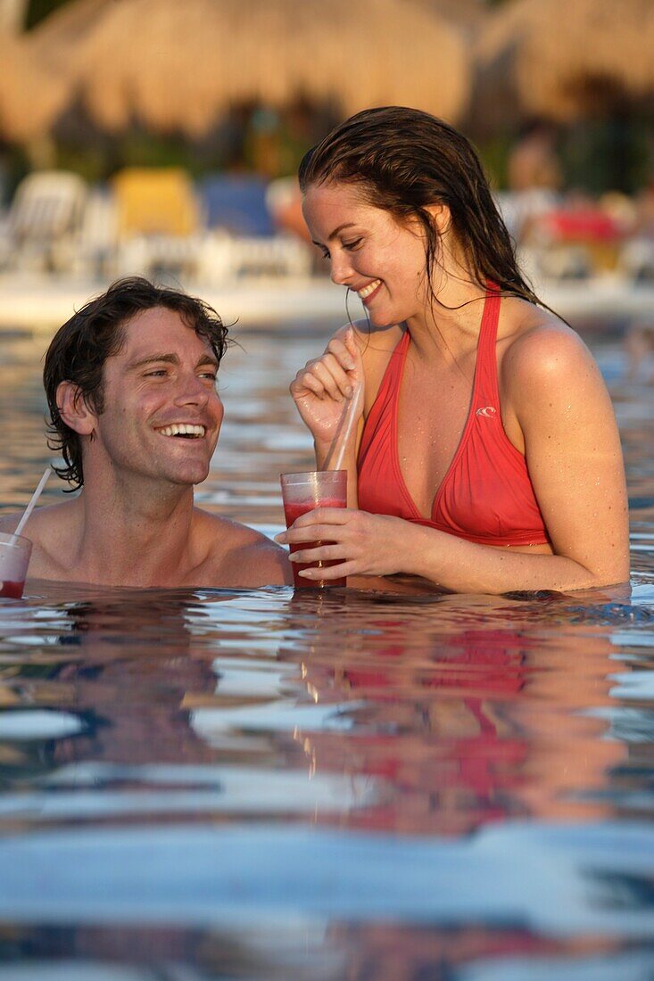 Young Couple Drinking Cocktails In Swimming Pool, Mayan Riviera,Yucatan Peninsular,Quintana Roo State,Mexico