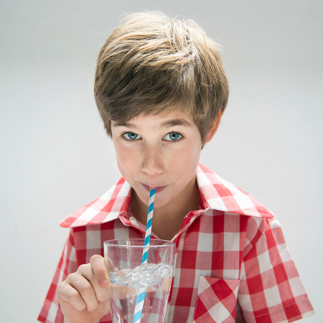 Boy drinking water with straw