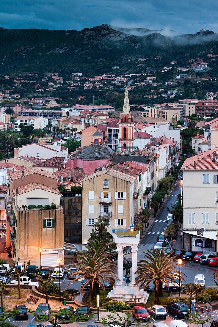 France, Corsica, Haute-Corse Department, La Balagne Region, Calvi, elevated city view above the Place Christophe Colomb, dusk