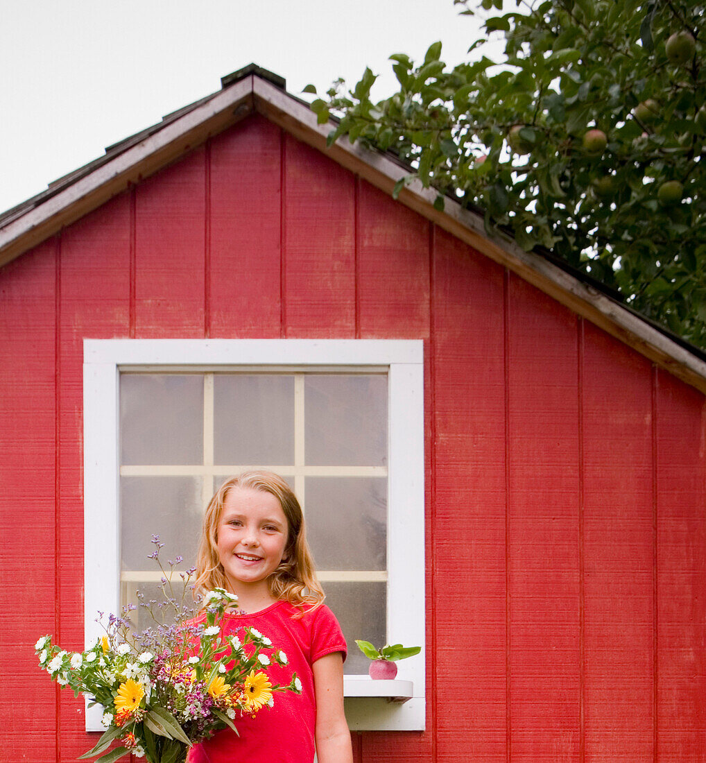 Girl with Flowers Standing infront of Shed