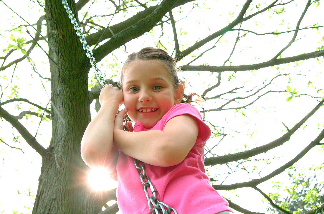 Girl Swinging from Tree