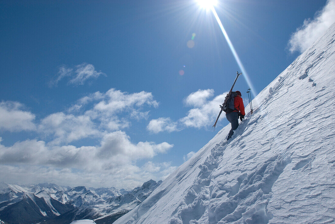 Skier climbing ridge of unnamed summit, Marriot Basin area, Coast Mountains, British Columbia