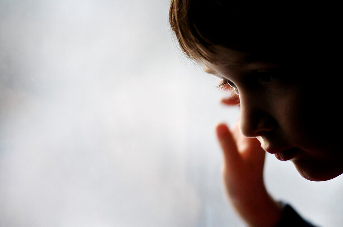 Profile of young boy against a frosted window, Otterburn Park, Quebec