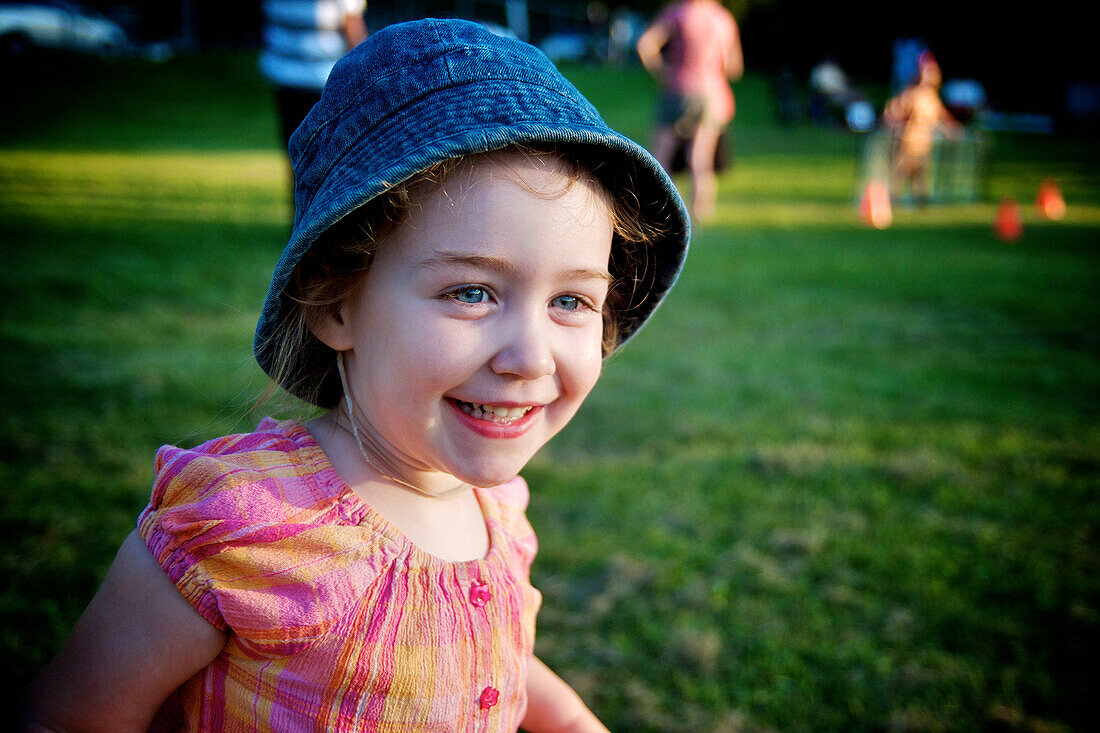 Young girl with blue denim hat and a big smile, Otterburn park, Quebec