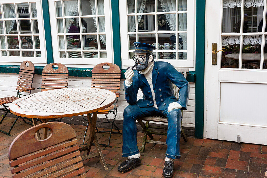 Figure of a sailor in front of a restaurant, Spiekeroog Island, Nationalpark, North Sea, East Frisian Islands, East Frisia, Lower Saxony, Germany, Europe