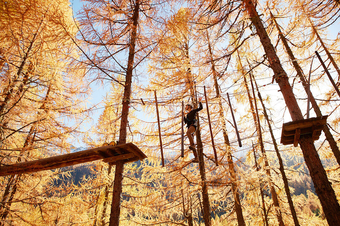 Woman in a high ropes course, Vernagt am See, Schnals Valley, South Tyrol, Italy