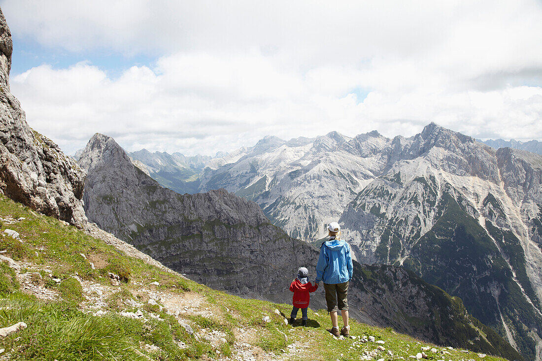 Mother and son looking at Karwendel valley, Mittenwald, Bavaria, Germany