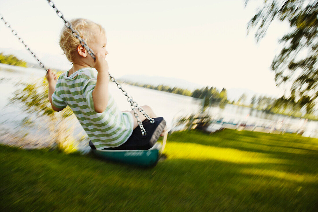 Boy swinging, Uffing am Staffelsee, Upper Bavaria, Bavaria, Germany