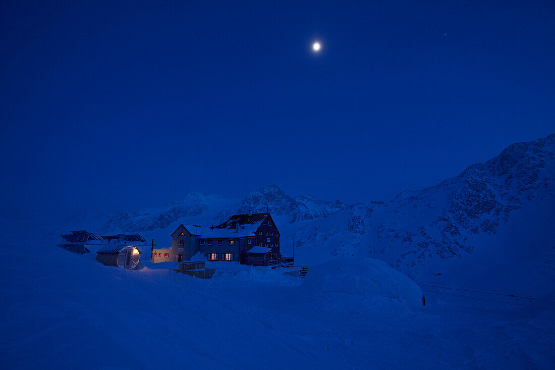 Full moon over mountain hut at night, Kurzras, Schnalstal, South Tyrol, Alto Adige, Italy