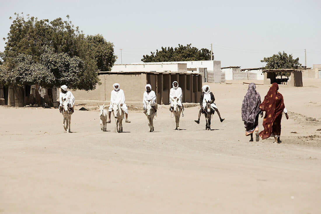 Men riding donkeys, Dongola, Northern, Sudan