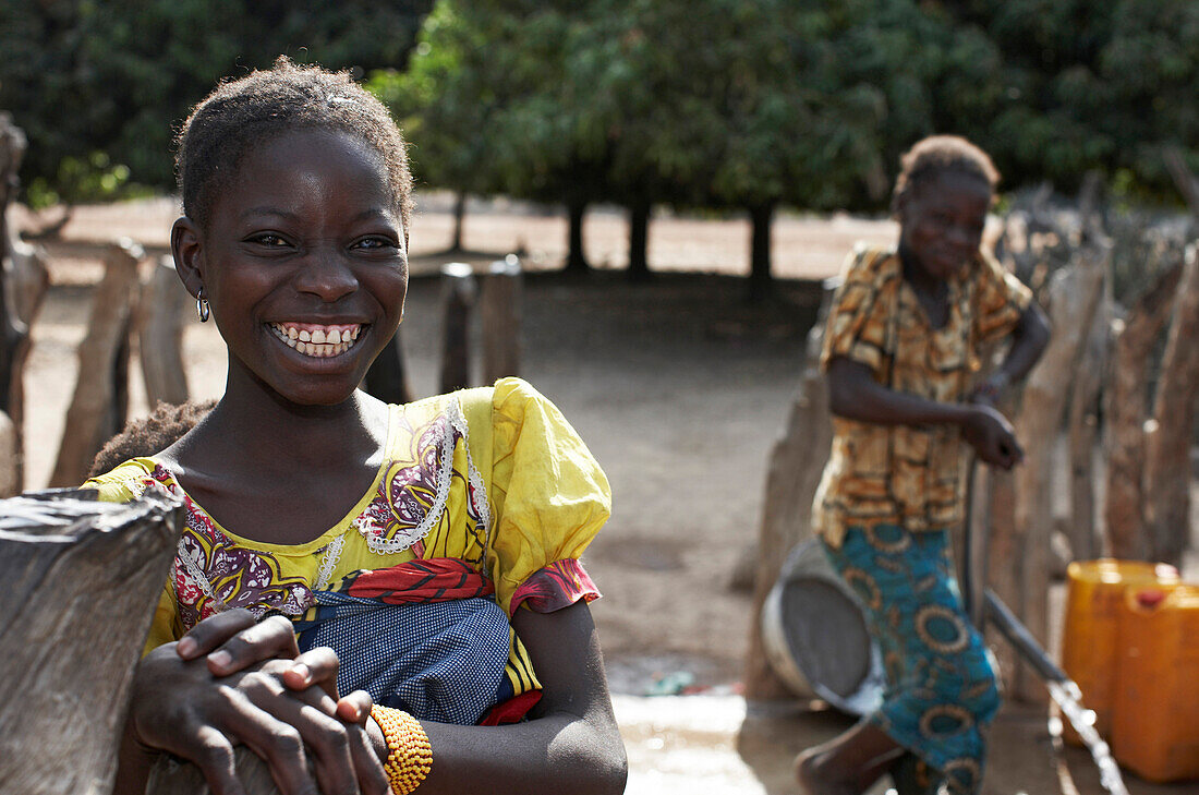 Two girls at a well, Magadala, Mali