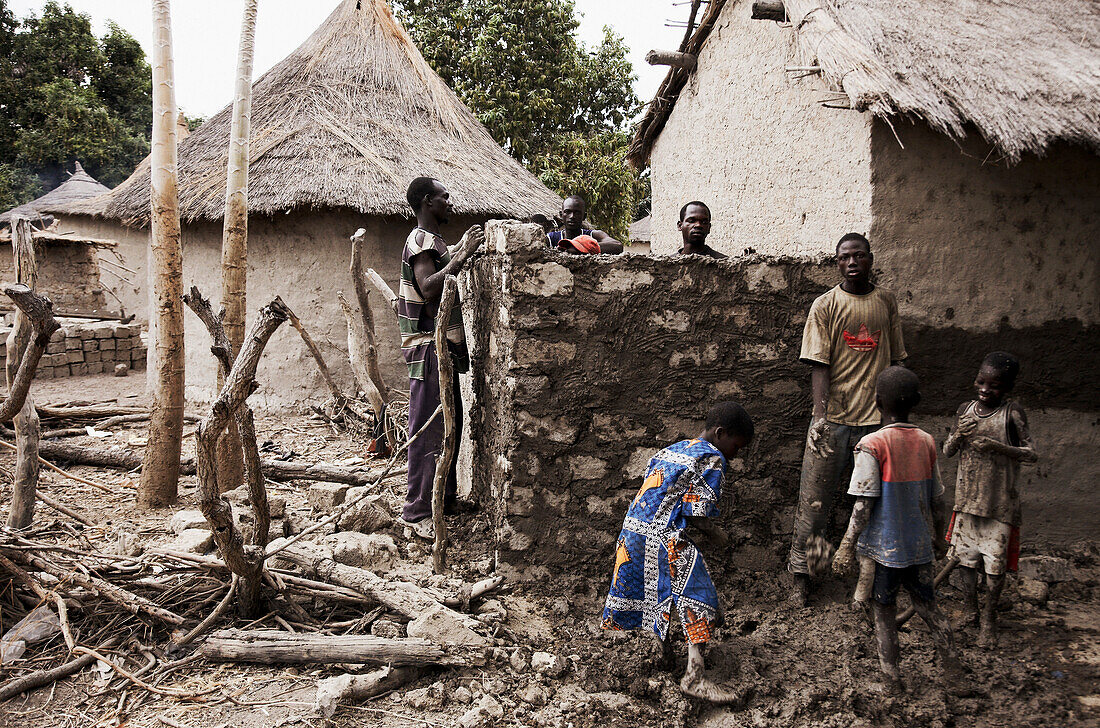 Villagers building an adobe hut, Magadala, Mali