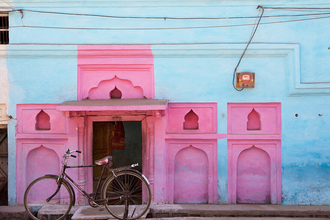 Altes Fahrrad vor farbenfroher Fassade, Khajuraho, Madhya Pradesh, Indien