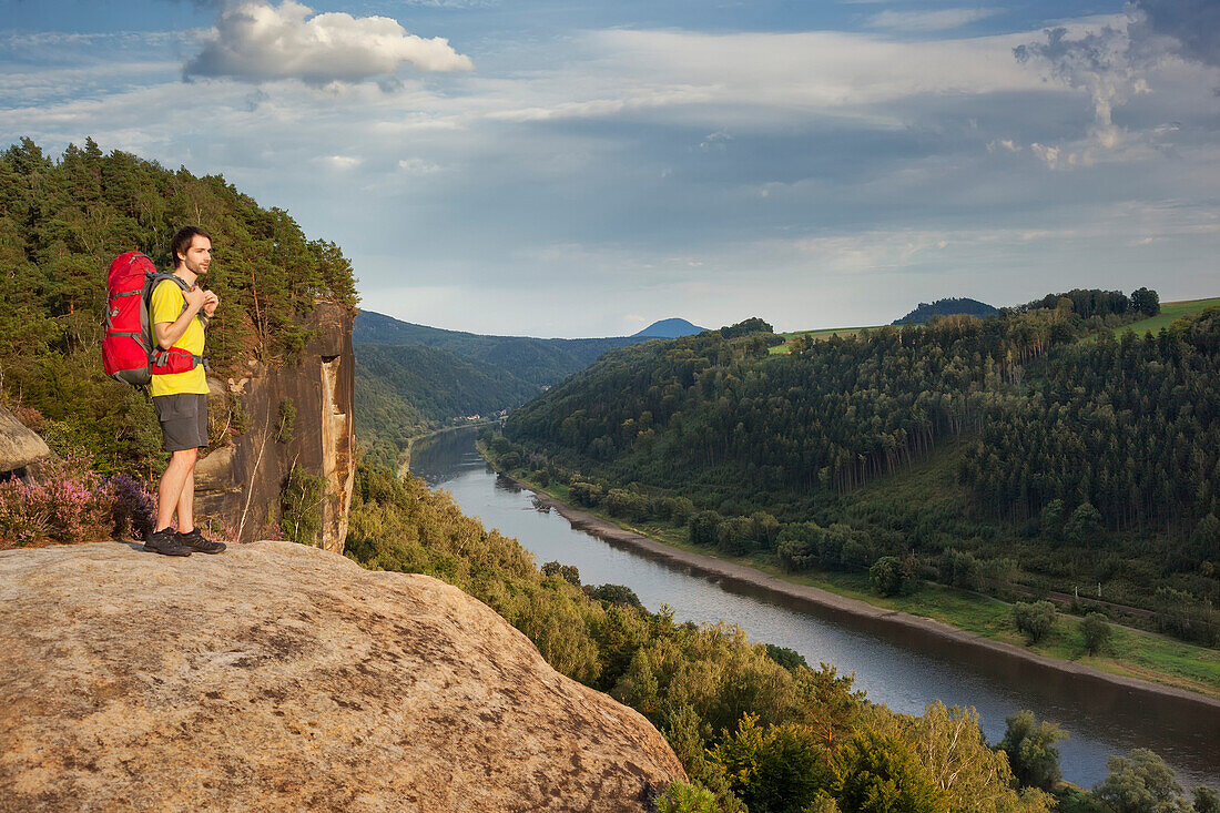 Young man enjoying view over river Elbe, Saxon Switzerland National Park, Saxony, Germany