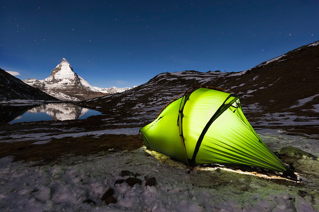 Illuminated tent at lake Riffelsee, Matterhorn in background, Zermatt, Canton of Valais, Switzerland